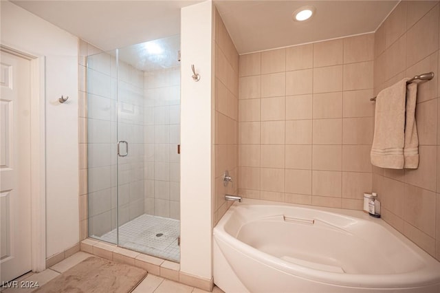 bathroom with a shower stall, a bath, tile patterned floors, and recessed lighting