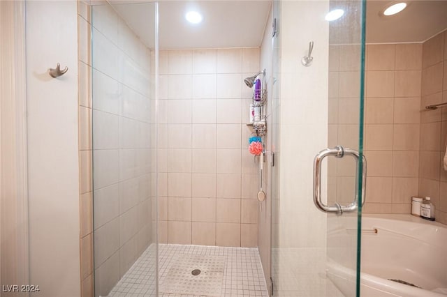 full bathroom with a stall shower, recessed lighting, and a tub
