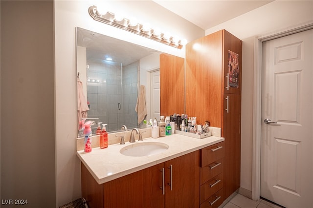 bathroom with walk in shower, vanity, and tile patterned floors