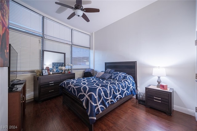 bedroom with ceiling fan, lofted ceiling, and dark wood-type flooring