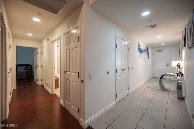 corridor with recessed lighting, baseboards, and wood finished floors