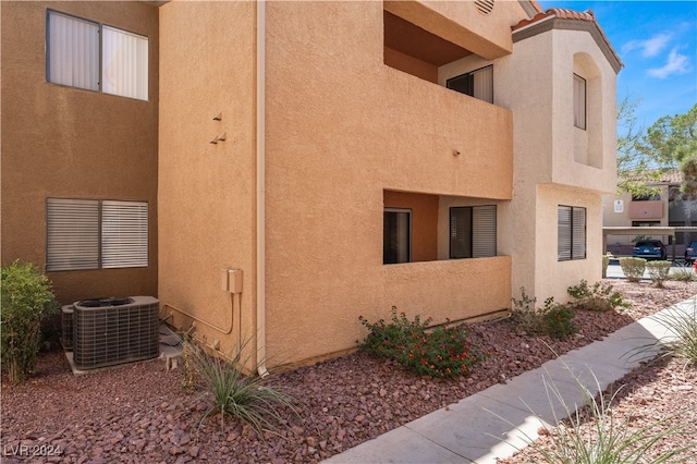 view of side of home featuring central AC