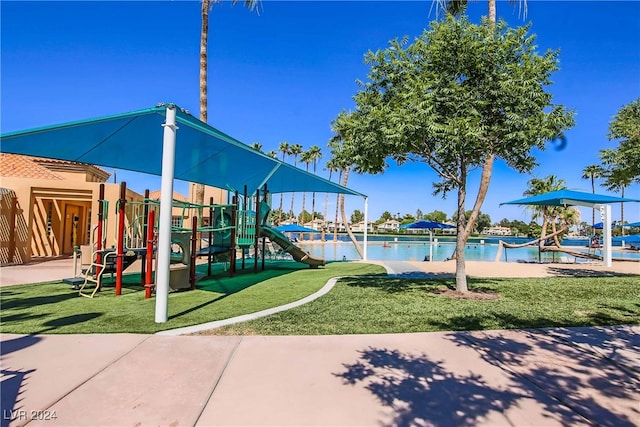 view of jungle gym featuring a water view