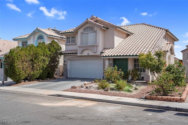 mediterranean / spanish-style home featuring a garage