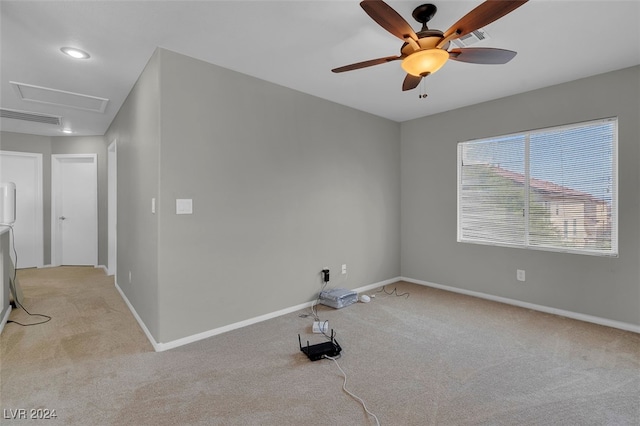 carpeted empty room featuring ceiling fan