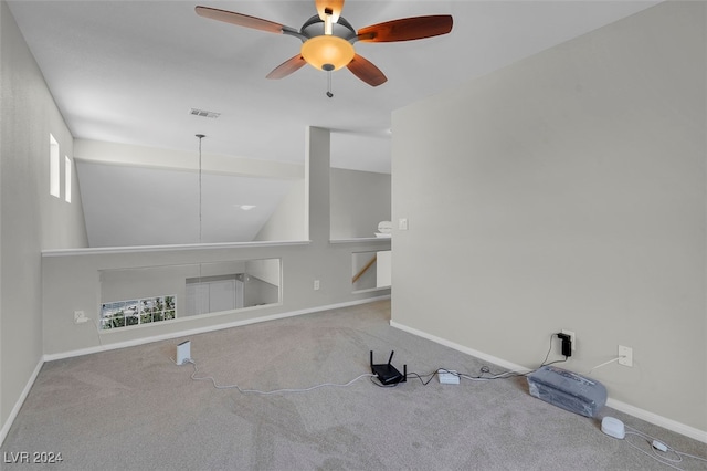 unfurnished room with ceiling fan, carpet flooring, and a wealth of natural light