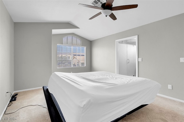 bedroom with light carpet, vaulted ceiling, and ceiling fan