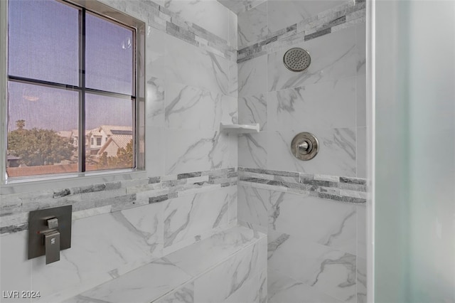 bathroom with a tile shower