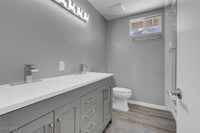 bathroom featuring hardwood / wood-style flooring, vanity, and toilet