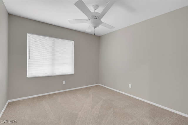 unfurnished room with ceiling fan and light colored carpet