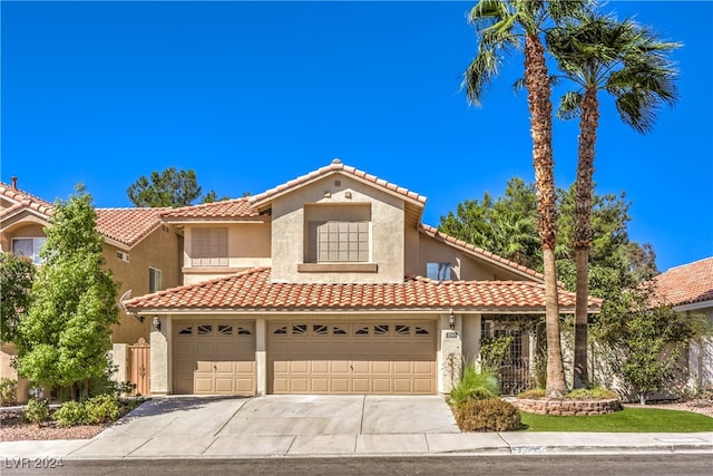 mediterranean / spanish house with a garage