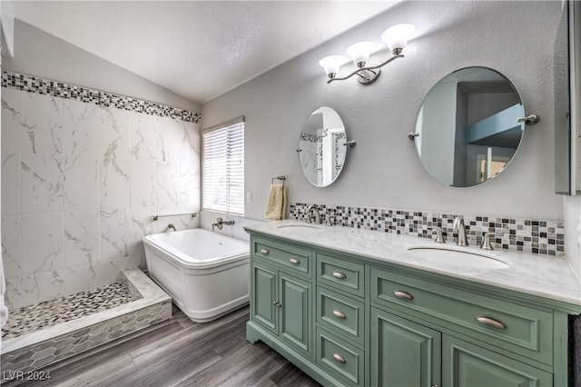 bathroom with vanity, lofted ceiling, wood-type flooring, a textured ceiling, and plus walk in shower