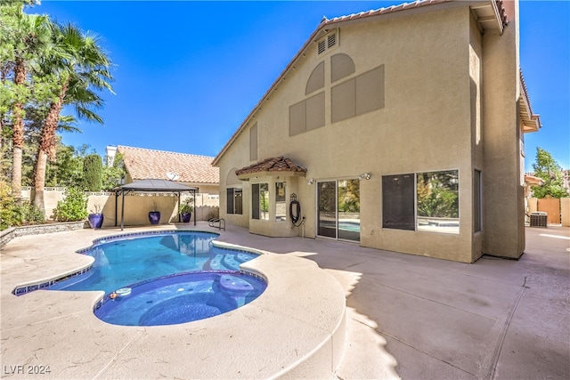 view of swimming pool with a gazebo, an in ground hot tub, and a patio area