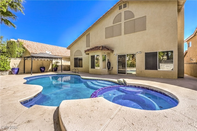 view of swimming pool with a gazebo, an in ground hot tub, and a patio area