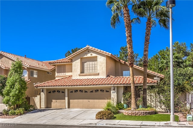 mediterranean / spanish-style house with a garage