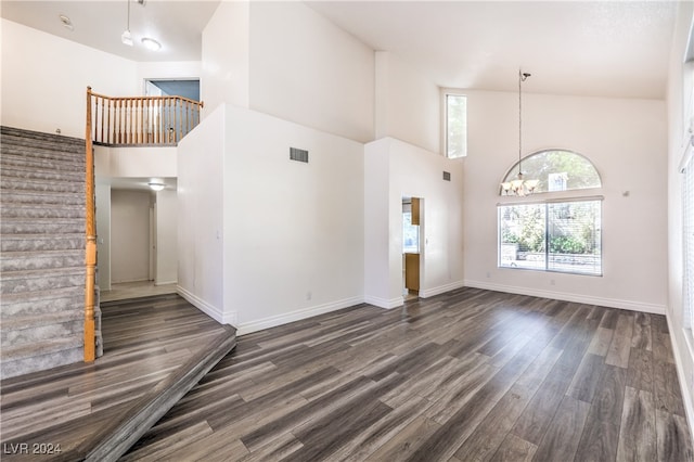 interior space with a notable chandelier, dark hardwood / wood-style floors, and high vaulted ceiling