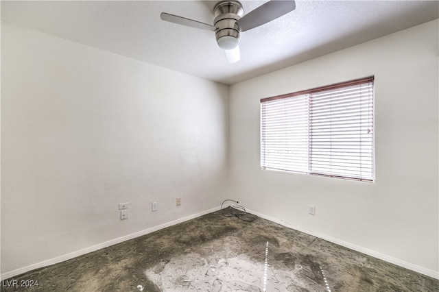 spare room featuring ceiling fan and a textured ceiling