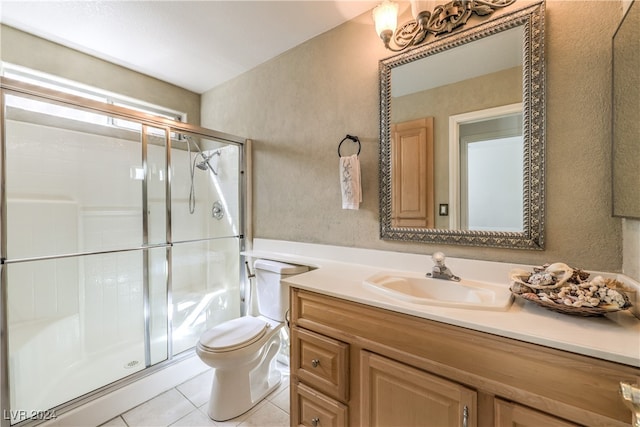 bathroom with vanity, tile patterned floors, an enclosed shower, and toilet