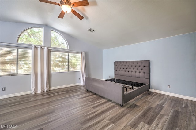 unfurnished bedroom with lofted ceiling, ceiling fan, and dark hardwood / wood-style floors