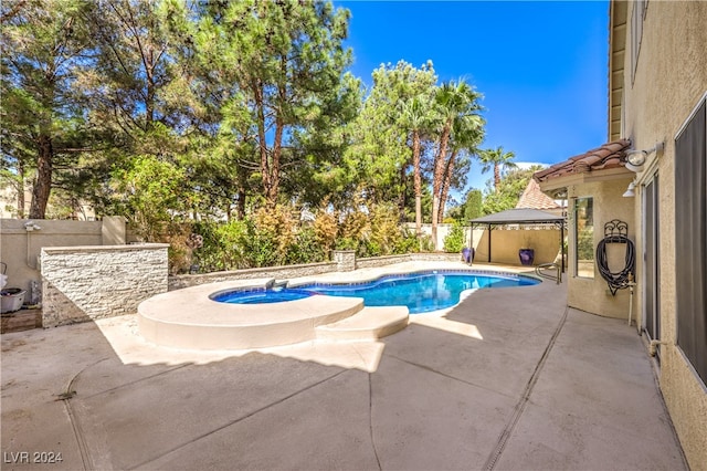 view of swimming pool with a gazebo, an in ground hot tub, and a patio area