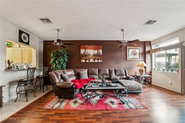 living room with ceiling fan and hardwood / wood-style flooring