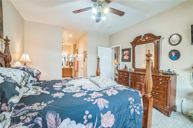 carpeted bedroom with ensuite bath and ceiling fan