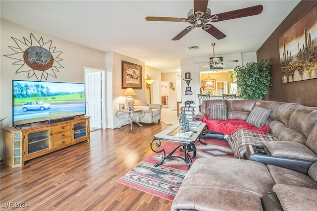 living room with ceiling fan and hardwood / wood-style flooring