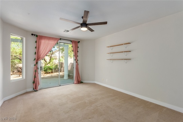 unfurnished room featuring ceiling fan and carpet flooring