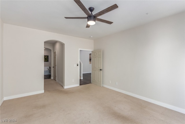 spare room featuring ceiling fan and light carpet