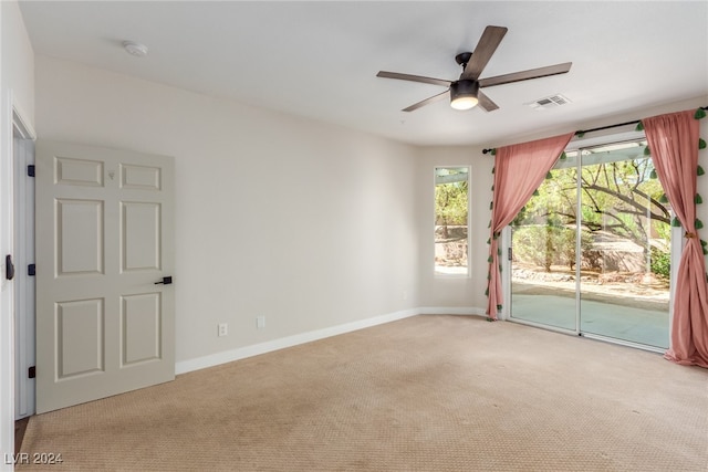 empty room featuring ceiling fan and light colored carpet