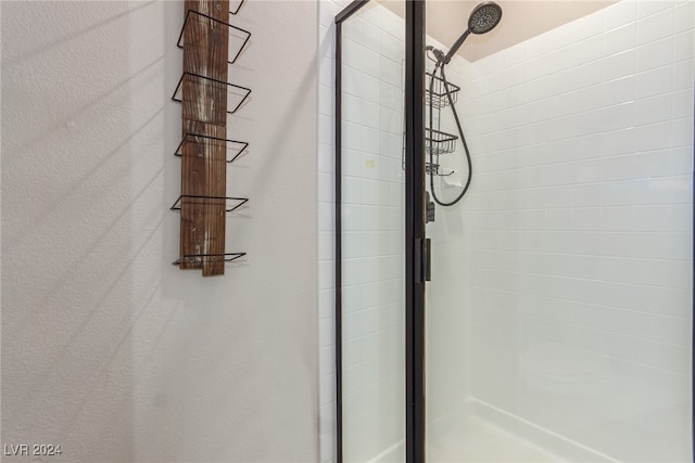 bathroom with a shower with door