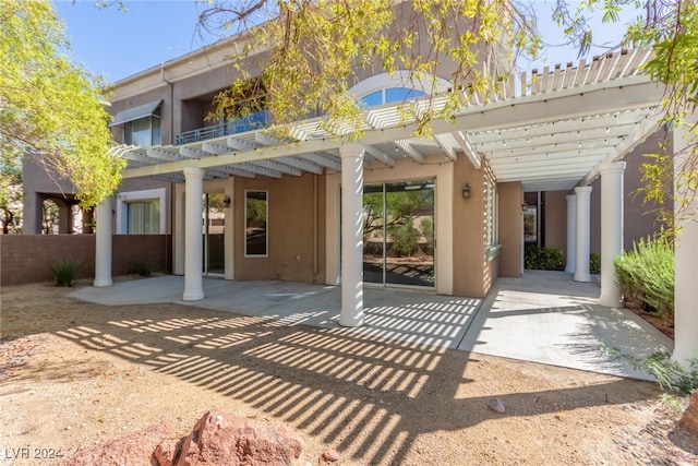 rear view of property with a pergola and a patio area