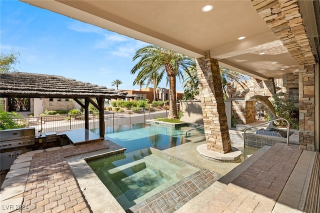 exterior space with a grill and a pool with hot tub