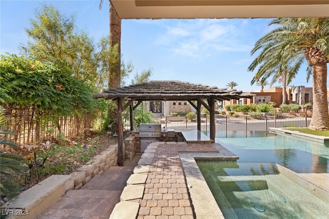 view of community with a swimming pool and an outdoor kitchen