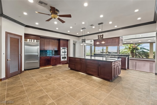 kitchen featuring decorative backsplash, stainless steel appliances, ceiling fan, decorative light fixtures, and sink