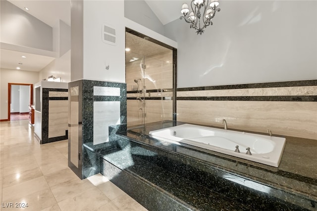 bathroom featuring shower with separate bathtub, tile walls, vaulted ceiling, an inviting chandelier, and tile patterned floors