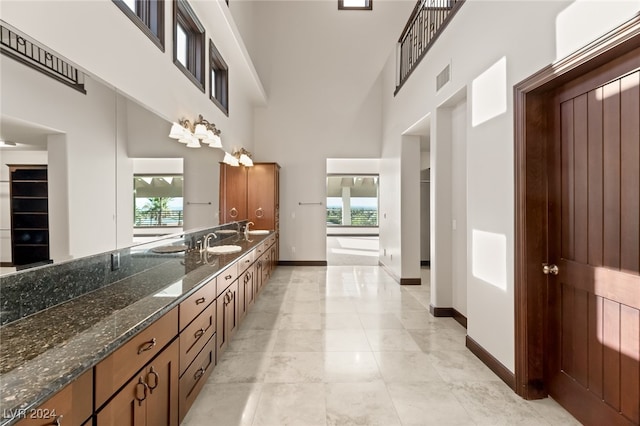 bathroom featuring a high ceiling and vanity