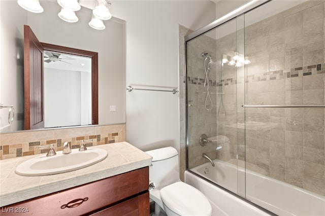 full bathroom featuring ceiling fan, enclosed tub / shower combo, vanity, backsplash, and toilet