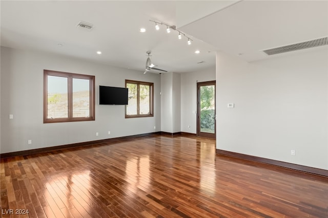 empty room featuring ceiling fan and dark wood-type flooring