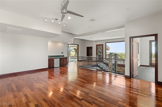 unfurnished living room featuring wood-type flooring and ceiling fan