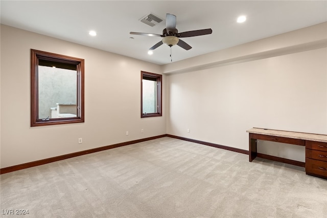 carpeted empty room featuring ceiling fan