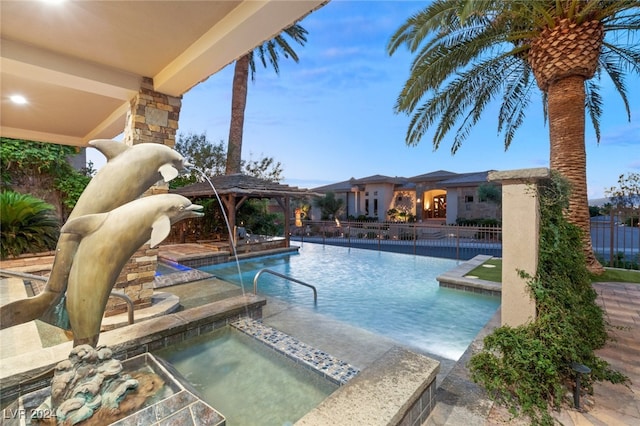 view of swimming pool with a patio, a hot tub, and pool water feature