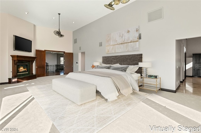 carpeted bedroom featuring a towering ceiling