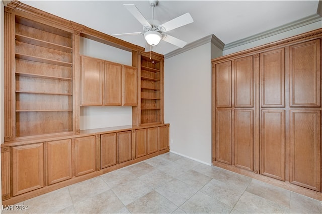 interior space with ornamental molding and ceiling fan