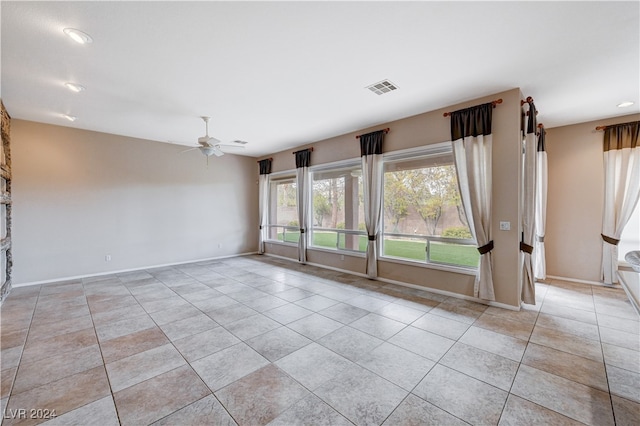 spare room with light tile patterned floors and ceiling fan