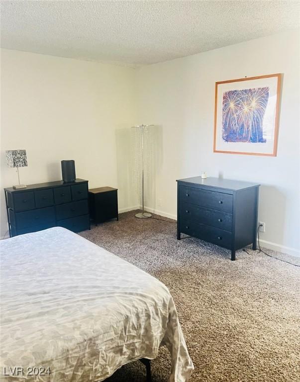 carpeted bedroom with a textured ceiling