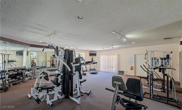 gym with a textured ceiling