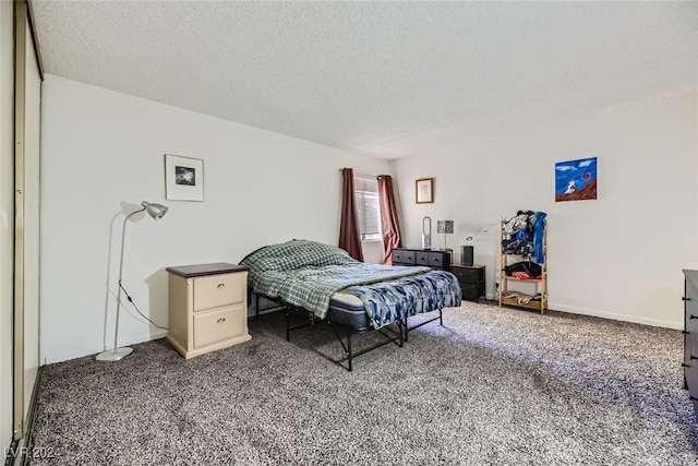 bedroom with carpet flooring and a textured ceiling