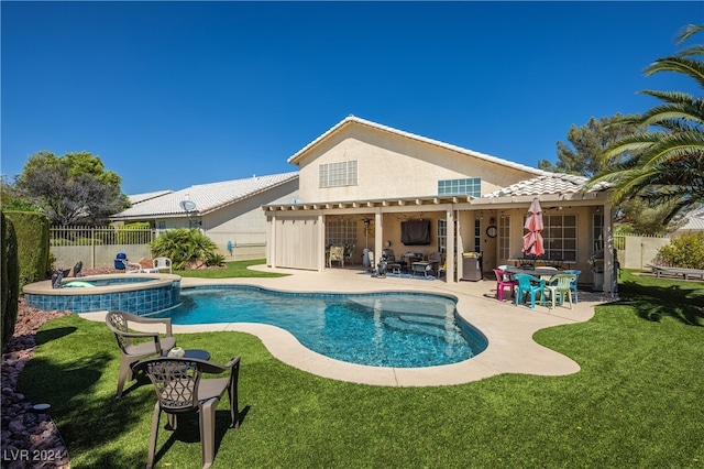 view of swimming pool with a patio, a lawn, and an in ground hot tub