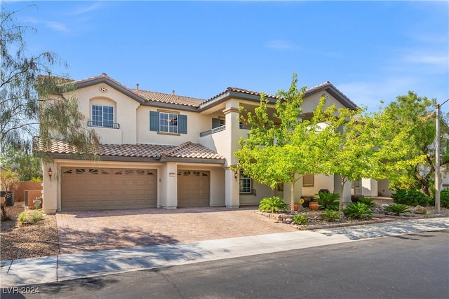 mediterranean / spanish-style home with a garage